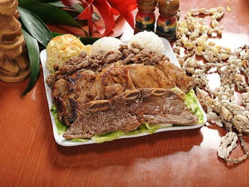 A hearty mixed grill plate with BBQ meats, rice, and mac salad at AHI Hawaiian BBQ, a Hawaiian Restaurant in Palmdale